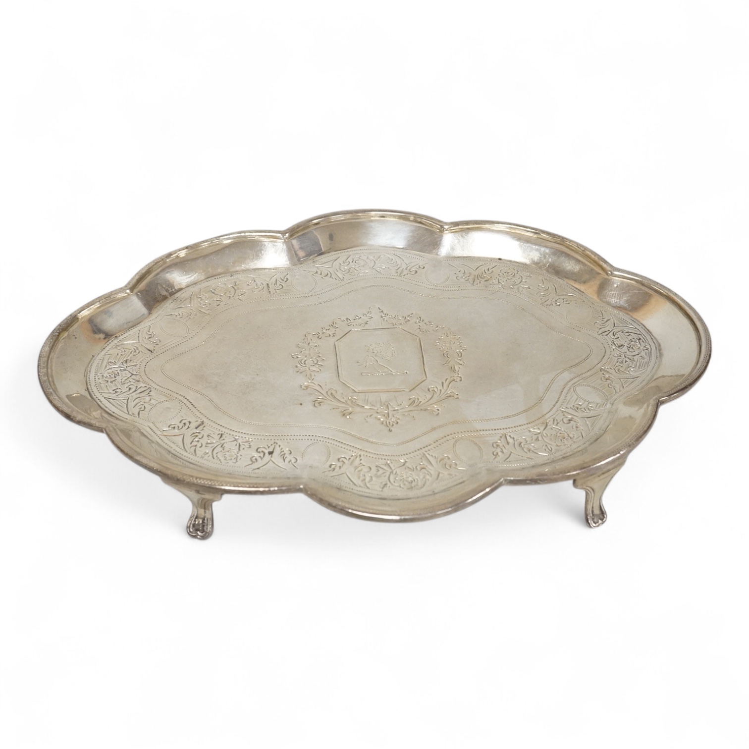 A George III silver cusped oval teapot stand, by Charles Aldridge, London, 1792, with engraved crest and foliate band, on four cabriole feet, London, 1792, 18.8cm, 5oz.